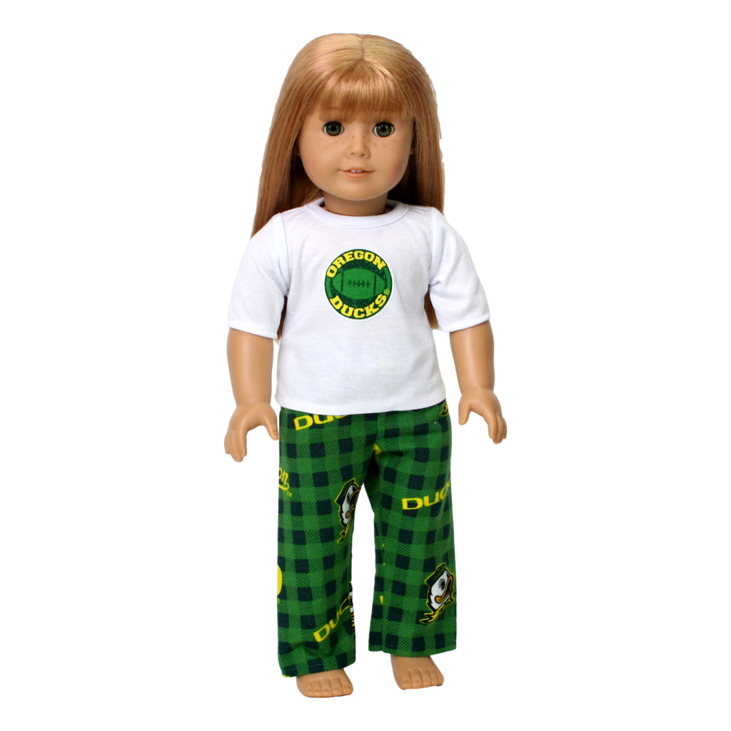 An 18-inch doll wearing a set of Oregon Duck Pajamas, consisting of a white t-shirt with the Oregon Ducks logo and green and yellow flannel pants with the logo.