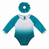 Teal and white leotard with sequins and matching scrunchie that fits an 18-inch doll on a white background