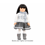 An 18-inch doll wearing a gray and white sweater and skirt set and wearing a gray scarf.