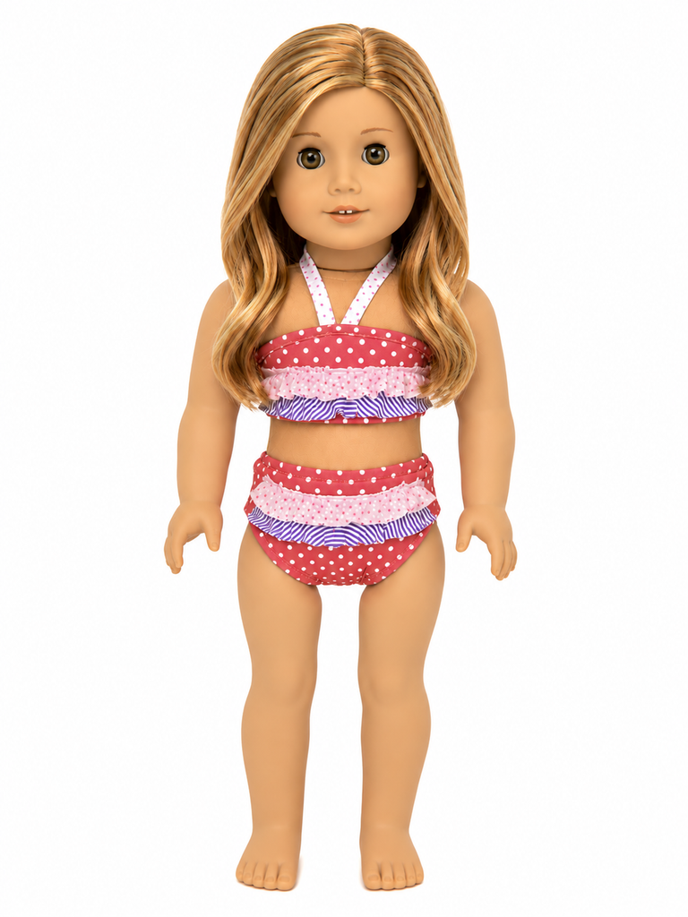 An 18-inch doll wearing a two-piece swimsuit with red and white polka-dot ruffles and purple and white striped ruffles, shown against a plain white background.