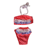 A red and white polka-dot two-piece ruffle swimsuit with halter top and matching bikini bottoms for 18-inch dolls.